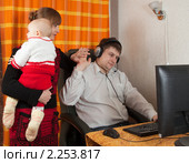 Жена с ребенком на руках мешает мужу работать на компьютере. Стоковое фото, фотограф Яков Филимонов / Фотобанк Лори