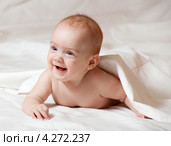 Счастливый полугодовалый ребенок лежит под одеялом. Стоковое фото, фотограф Яков Филимонов / Фотобанк Лори