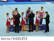 Чемпионат Европы по спортивной гимнастике 2013 года. Москва, СК "Олимпийский". Награждение победителей состязаний на парралельных брусьях - Олег Степко, Лукас Фишер и Давид Белявский. В церемонии принимает участие известный российский гимнаст Алексей Немов. Редакционное фото, фотограф Игорь Долгов / Фотобанк Лори