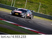 Автомобиль BMW M3 DTM команды Audi Sport Team Abt (гонщик Timo Scheider ) участвует в гоночной серии кузовных автомобилей Deutsche Tourenwagen Masters на трассе Moscow Raceway в Подмосковье 3 августа 2013. Редакционное фото, фотограф Николай Винокуров / Фотобанк Лори