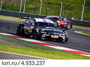 Автомобиль BMW M3 DTM команды BMW Team Schnitzer (гонщик Bruno Spengler) участвует в гоночной серии кузовных автомобилей Deutsche Tourenwagen Masters на трассе Moscow Raceway в Подмосковье 3 августа 2013. Редакционное фото, фотограф Николай Винокуров / Фотобанк Лори