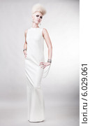 blond attractive woman in white dress with creative hairstyle. Стоковое фото, фотограф Александр Буц / Фотобанк Лори