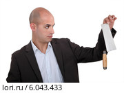 Unenthusiastic businessman holding trowel. Стоковое фото, фотограф Phovoir Images / Фотобанк Лори