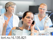 Impolite businesswoman on phone in dental office. Стоковое фото, фотограф CandyBox Images / Фотобанк Лори