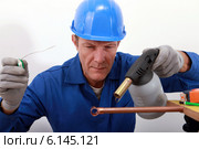 craftsman soldering a copper pipe. Стоковое фото, фотограф Phovoir Images / Фотобанк Лори