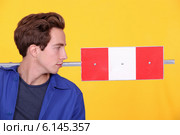 Man stood with road sign in studio. Стоковое фото, фотограф Phovoir Images / Фотобанк Лори