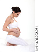 Pregnant woman touching belly. Стоковое фото, фотограф Phovoir Images / Фотобанк Лори