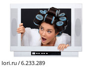 Woman escaping from television set. Стоковое фото, фотограф Phovoir Images / Фотобанк Лори