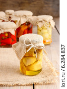 Glass jar of pickled mushrooms on wooden table. Autumn dish. Стоковое фото, агентство BE&W Photo / Фотобанк Лори
