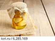 Glass jar of pickled mushrooms on wooden table. Autumn dish. Стоковое фото, агентство BE&W Photo / Фотобанк Лори