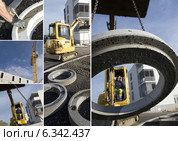 Construction vehicle lifting concrete ring. Стоковое фото, фотограф Phovoir Images / Фотобанк Лори