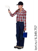Angry tradeswoman holding a paint roller. Стоковое фото, фотограф Phovoir Images / Фотобанк Лори