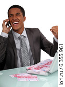 Ecstatic businessman with a briefcase full of money. Стоковое фото, фотограф Phovoir Images / Фотобанк Лори