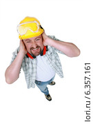 Landscape picture of worker covering his ears. Стоковое фото, фотограф Phovoir Images / Фотобанк Лори