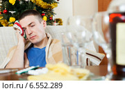 Guy having hangover after celebrating New year. Стоковое фото, фотограф Яков Филимонов / Фотобанк Лори