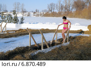 Девушка входит в прорубь. Крещенские морозы 19 января (2014 год). Редакционное фото, фотограф Александр Тараканов / Фотобанк Лори