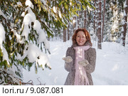 Happy red-haired woman having fun on win. Стоковое фото, фотограф Roberts Ratuts / PantherMedia / Фотобанк Лори