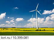 Windmills in the fields of yellow rape, renewable energy generators. Стоковое фото, фотограф Artur Wojteczek / PantherMedia / Фотобанк Лори