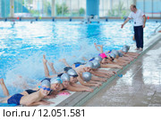 group of happy kids children at swimming pool class learning to swim. Стоковое фото, фотограф Benis Arapovic / PantherMedia / Фотобанк Лори