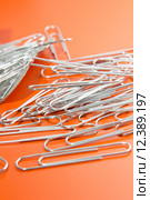 paper clips to orange background. Стоковое фото, фотограф Nicola Galiero / PantherMedia / Фотобанк Лори