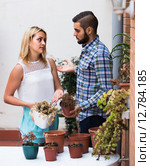 man making excuses for not watering girlfriends flowers. Стоковое фото, фотограф Яков Филимонов / Фотобанк Лори