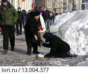 Неравнодушные прохожие подают милостыню нищей старушке на Моховой улице в Москве (2010 год). Редакционное фото, фотограф lana1501 / Фотобанк Лори