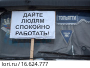 Плакат с надписью "Дайте людям спокойно работать!" на лобовом стекле грузового автомобиля на парковке дальнобойщиков в городе Химки, Россия (2015 год). Редакционное фото, фотограф Николай Винокуров / Фотобанк Лори