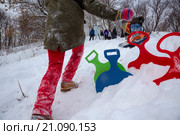 Молодые люди катаются на ледянках в парке с горки в снежную зиму (2016 год). Редакционное фото, фотограф Николай Винокуров / Фотобанк Лори