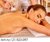 Young woman receiving electric facial massage. Стоковое фото, фотограф Gennadiy Poznyakov / Фотобанк Лори