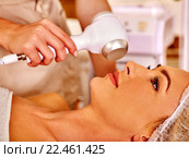 Young woman receiving electric facial massage. Стоковое фото, фотограф Gennadiy Poznyakov / Фотобанк Лори