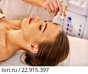Young woman receiving electric facial massage. Стоковое фото, фотограф Gennadiy Poznyakov / Фотобанк Лори