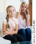 Worried mother calling doctor for daughter with abdominal pains. Стоковое фото, фотограф Яков Филимонов / Фотобанк Лори