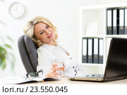 senior business woman relaxing at work in office. Стоковое фото, фотограф Оксана Кузьмина / Фотобанк Лори