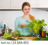 Young housewife tired of cooking vegetables in domestic kitchen. Стоковое фото, фотограф Яков Филимонов / Фотобанк Лори
