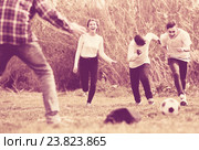 girl and three boys playing football in spring park and smiling. Стоковое фото, фотограф Яков Филимонов / Фотобанк Лори