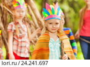 Blond girl in Injun's costume playing with friends. Стоковое фото, фотограф Сергей Новиков / Фотобанк Лори