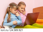 Две девочки ковыряют в носу и смотрят в экран ноутбука. Стоковое фото, фотограф Иванов Алексей / Фотобанк Лори