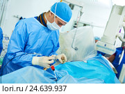 Interventional cardiology. Male surgeon doctor at operation. Стоковое фото, фотограф Дмитрий Калиновский / Фотобанк Лори
