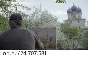 Concept Religion. Skilled Artist Draws Temple in Flowering Garden. Follow Focus. Стоковое видео, видеограф Vladimir Botkin / Фотобанк Лори