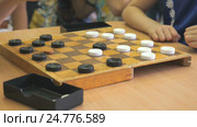 Children play checkers at a kindergarten. Close-up. Стоковое видео, видеограф worker / Фотобанк Лори