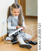 Little girl playing with sockets at home. Стоковое фото, фотограф Яков Филимонов / Фотобанк Лори
