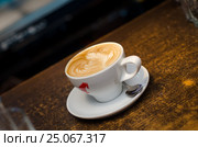 A cup of coffee in a white cup on wooden background. Стоковое фото, фотограф Oleg Klyuchinskiy / Фотобанк Лори