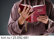 Monk in religious concept on gray background. Стоковое фото, фотограф Elnur / Фотобанк Лори