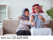 Young arab muslim family with pregnant wife expecting baby. Стоковое фото, фотограф Elnur / Фотобанк Лори