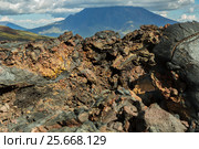 Lava field at Tolbachik volcano, after eruption in 2012 on background Big Udina volcano, Kamchatka (2016 год). Редакционное фото, фотограф Юлия Машкова / Фотобанк Лори