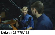Attractive happy radio host interviewing a guest in studio. Стоковое видео, видеограф Виктор Аллин / Фотобанк Лори