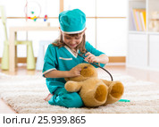 Cute kid girl playing doctor with plush toy at home. Стоковое фото, фотограф Оксана Кузьмина / Фотобанк Лори