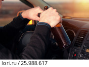 Young drunk man driving a car and drinking beer. Стоковое фото, фотограф Pavel Biryukov / Фотобанк Лори