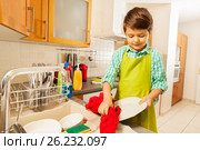 Boy standing next to the sink and wiping dry plate. Стоковое фото, фотограф Сергей Новиков / Фотобанк Лори