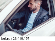 Stylish man with a beard and in sunglasses is sitting in the car. Стоковое фото, фотограф Женя Канашкин / Фотобанк Лори